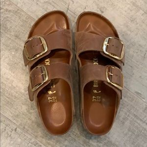 Brown leather Birkenstock sandal with gold buckle